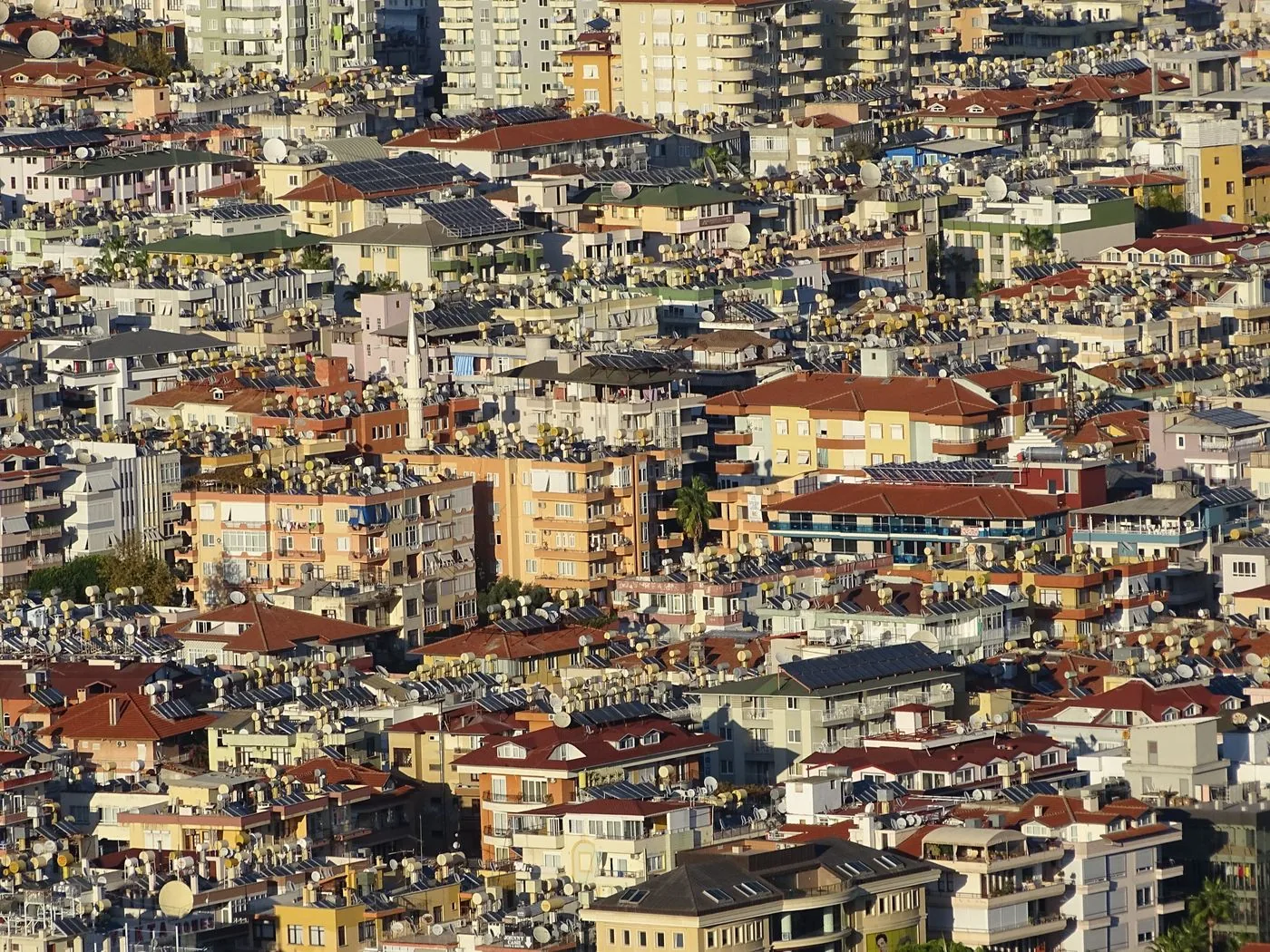 Closely built apartment blocks with red-brown roofs in Alanya